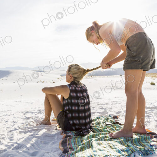 13 year old girl braiding her mothers hair, White Sands Nat'l Monument, NM 13 year old girl braiding her mothers hair, White Sands Nat'l Monument, NM