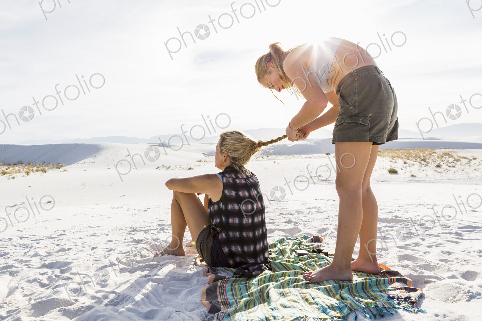 13 year old girl braiding her mothers hair, White Sands Nat’l Monument, NM