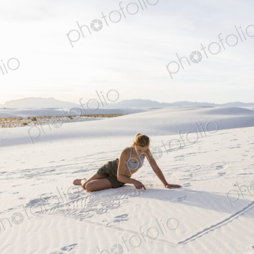 13 year old girl drawing in the sand, White Sands Nat'l Monument, NM
