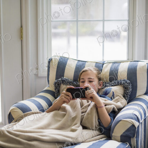 13 year old girl looking at smart phone 13 year old girl looking at smart phone