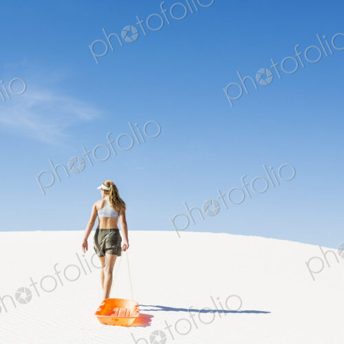 13 year old girl pulling sled in White Sands Nat'l Monument NM 13 year old girl pulling sled in White Sands Nat'l Monument NM