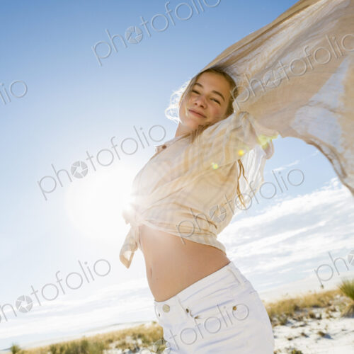 13 year old girl with arms raised holding a light shawl dancing in open space. 13 year old girl with arms raised holding a light shawl dancing in open space.