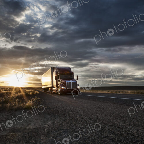 3/4 front view of a commercial truck on the road at sunset in eastern Washington, USA 3/4 front view of a commercial truck on the road at sunset in eastern Washington, USA