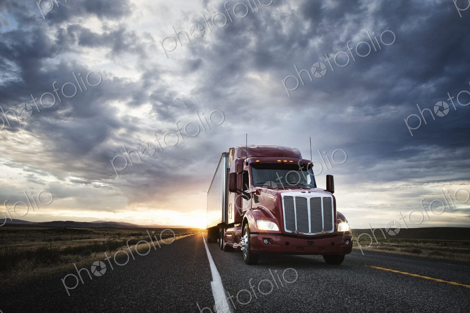 3/4 front view of a commercial truck on the road at sunset in eastern Washington, USA