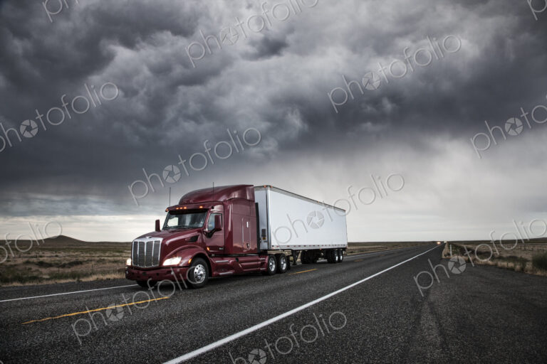 3/4 front view of a commercial truck on the road at sunset in eastern Washington, USA