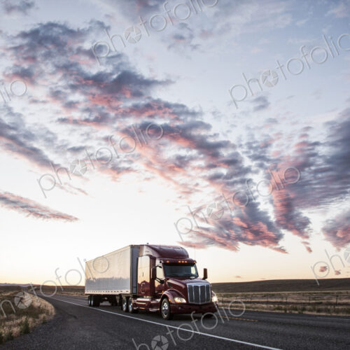 3/4 front view of a commercial truck on the road at sunset in eastern Washington, USA