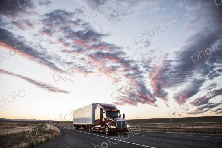 3/4 front view of a commercial truck on the road at sunset in eastern Washington, USA