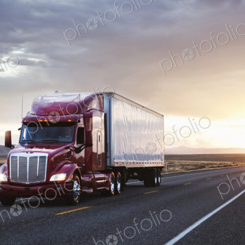 3/4 front view of a commercial truck on the road at sunset in eastern Washington, USA