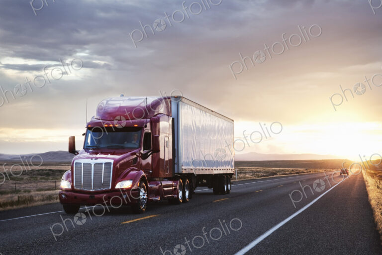 3/4 front view of a commercial truck on the road at sunset in eastern Washington, USA