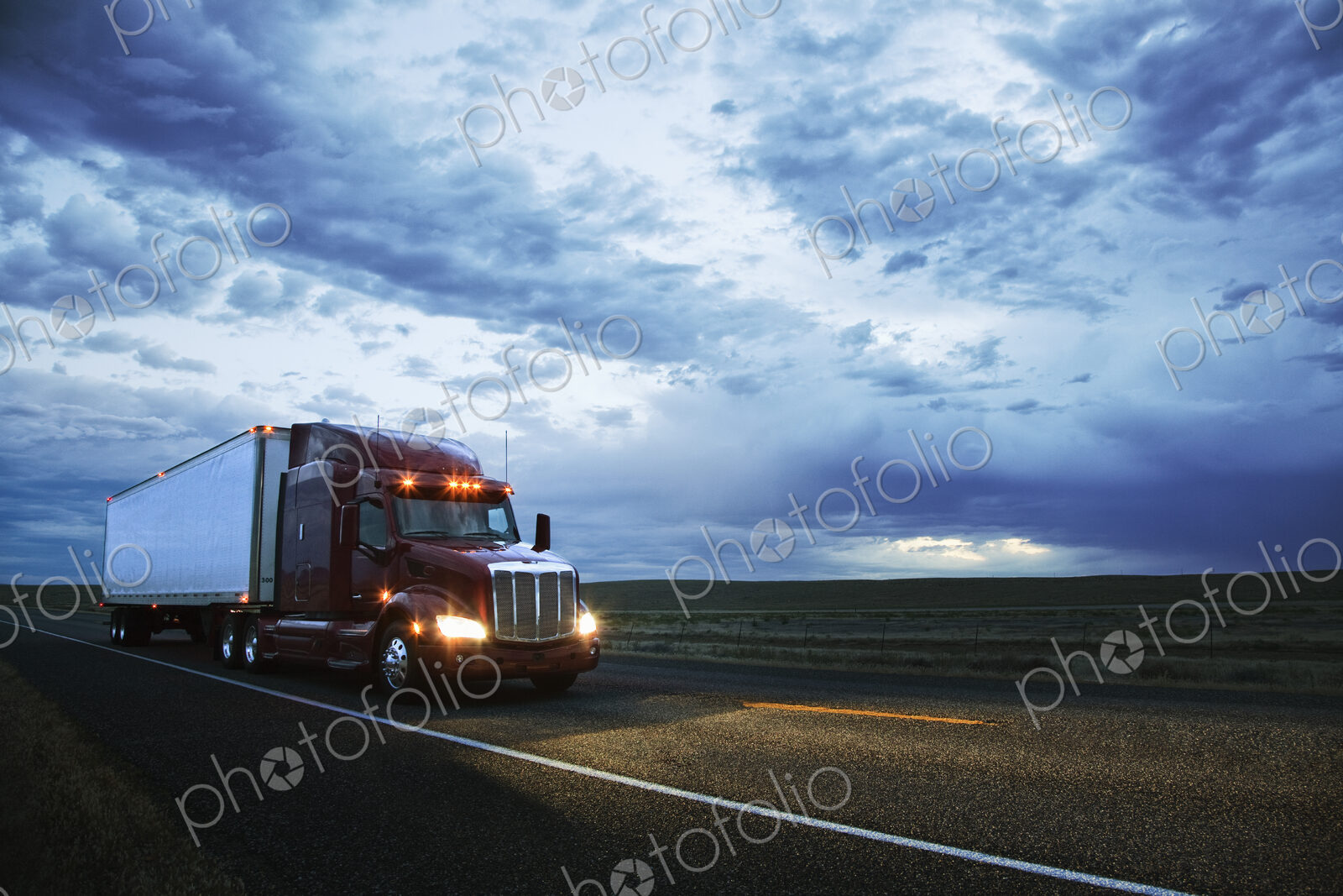 3/4 front view of a commercial truck on the road in the early evening in eastern…