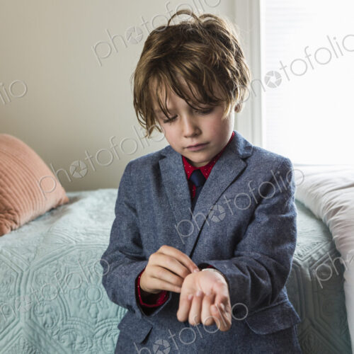6 year old boy adjusting his watch band 6 year old boy adjusting his watch band