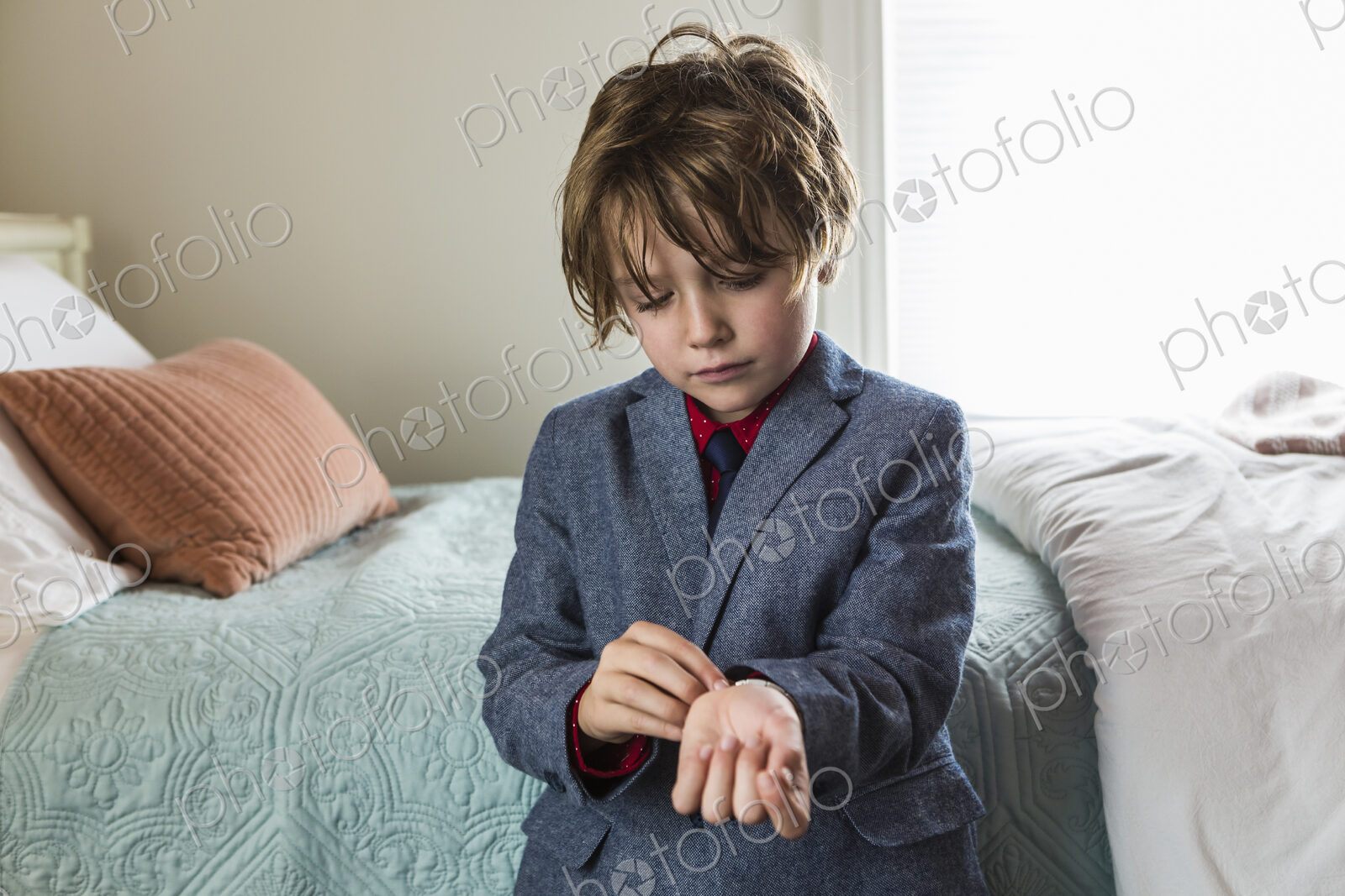 6 year old boy adjusting his watch band