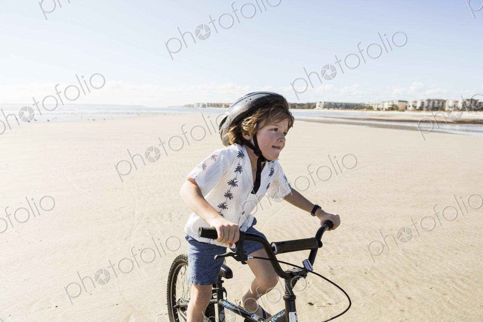 6 year old boy biking on beach, St. Simon’s Island, Georgia