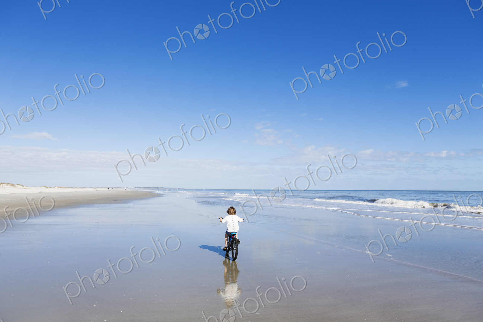6 year old boy biking on beach, St. Simon’s Island, Georgia