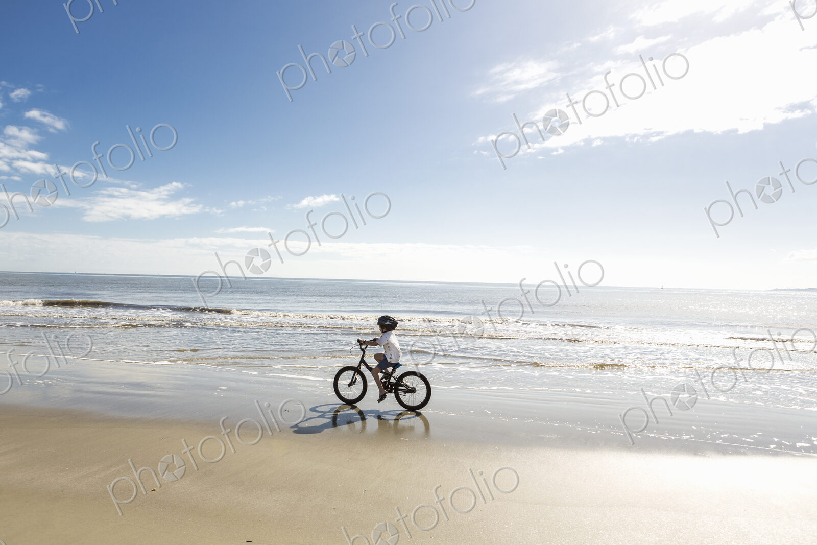 6 year old boy biking on beach, St. Simon’s Island, Georgia