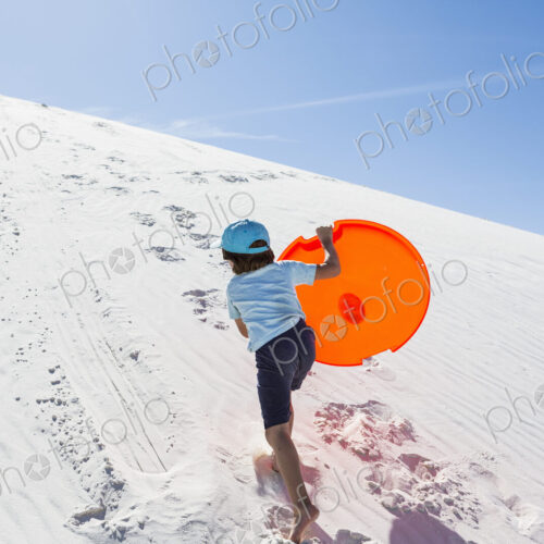 6 year old boy climbing sand dune 6 year old boy climbing sand dune