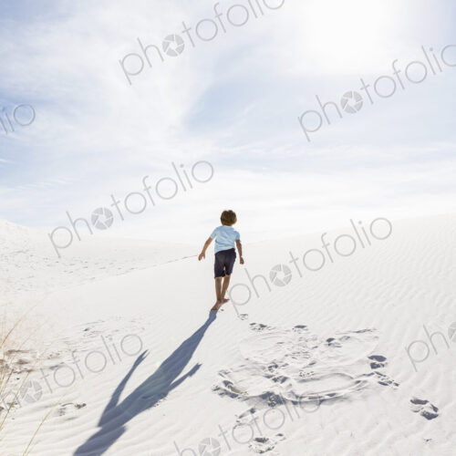 6 year old boy climbing sand dune 6 year old boy climbing sand dune