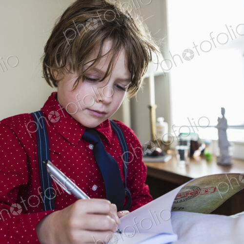 6 year old boy drawing on sketch pad in