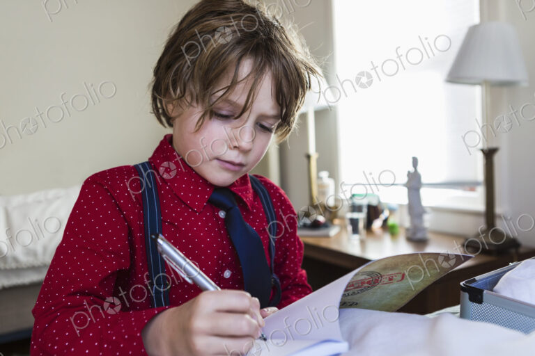 6 year old boy drawing on sketch pad in