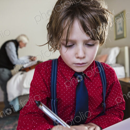 6 year old boy drawing on sketch pad in