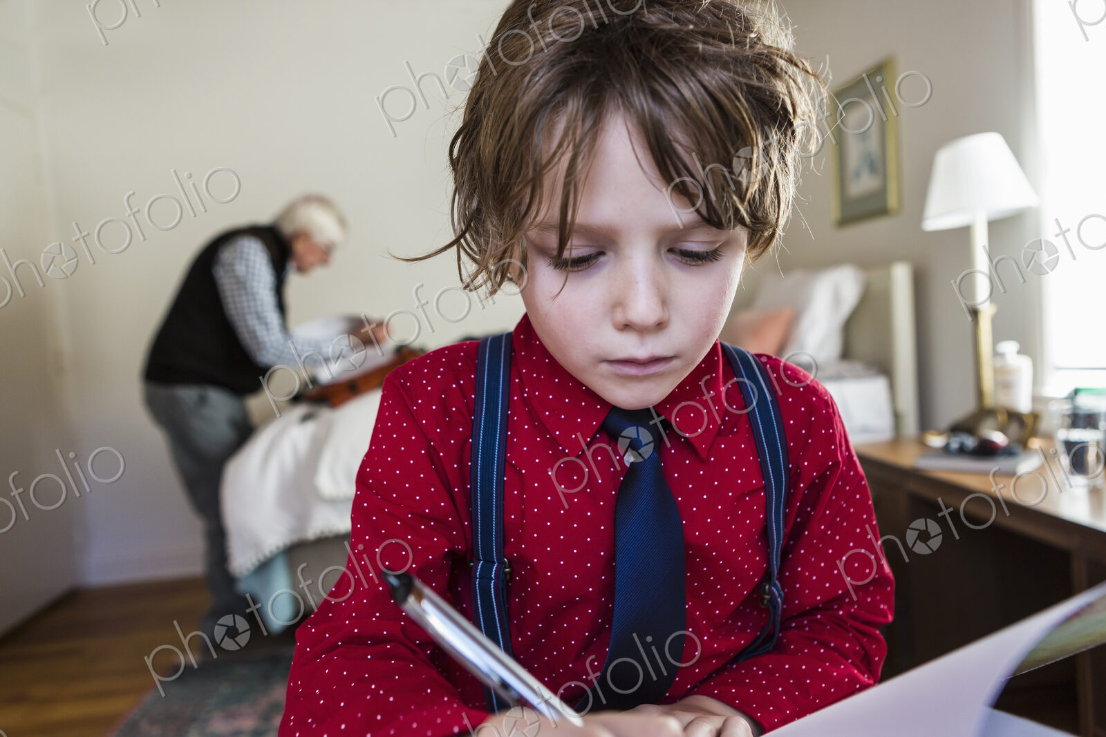 6 year old boy drawing on sketch pad in