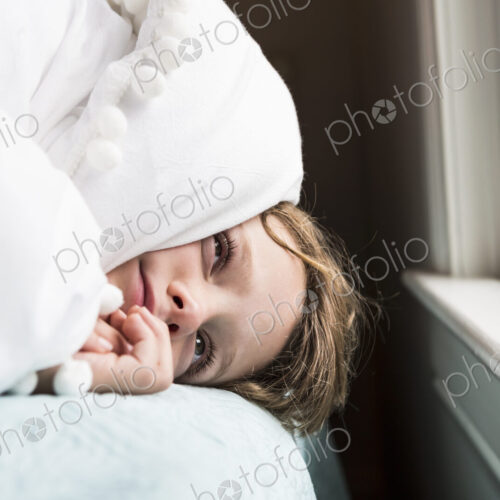6 year old boy in bed with covers over his head