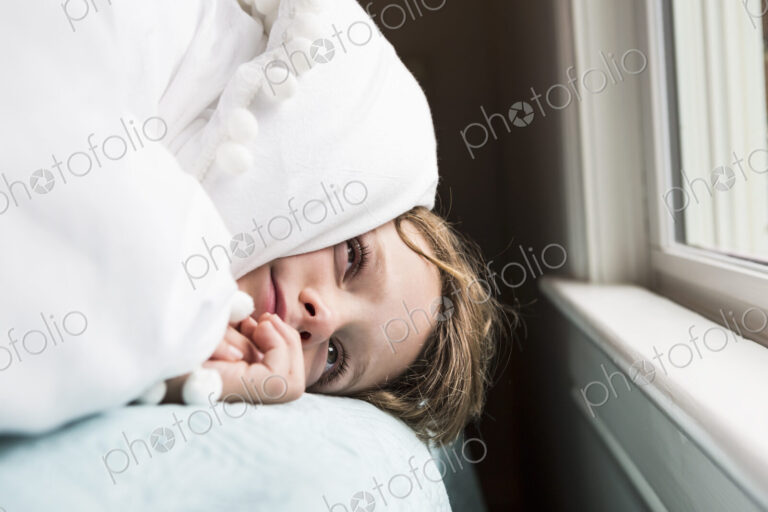 6 year old boy in bed with covers over his head