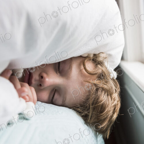 6 year old boy in bed with covers over his head