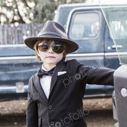 6 year old boy leaning on car open car door 6 year old boy leaning on car open car door