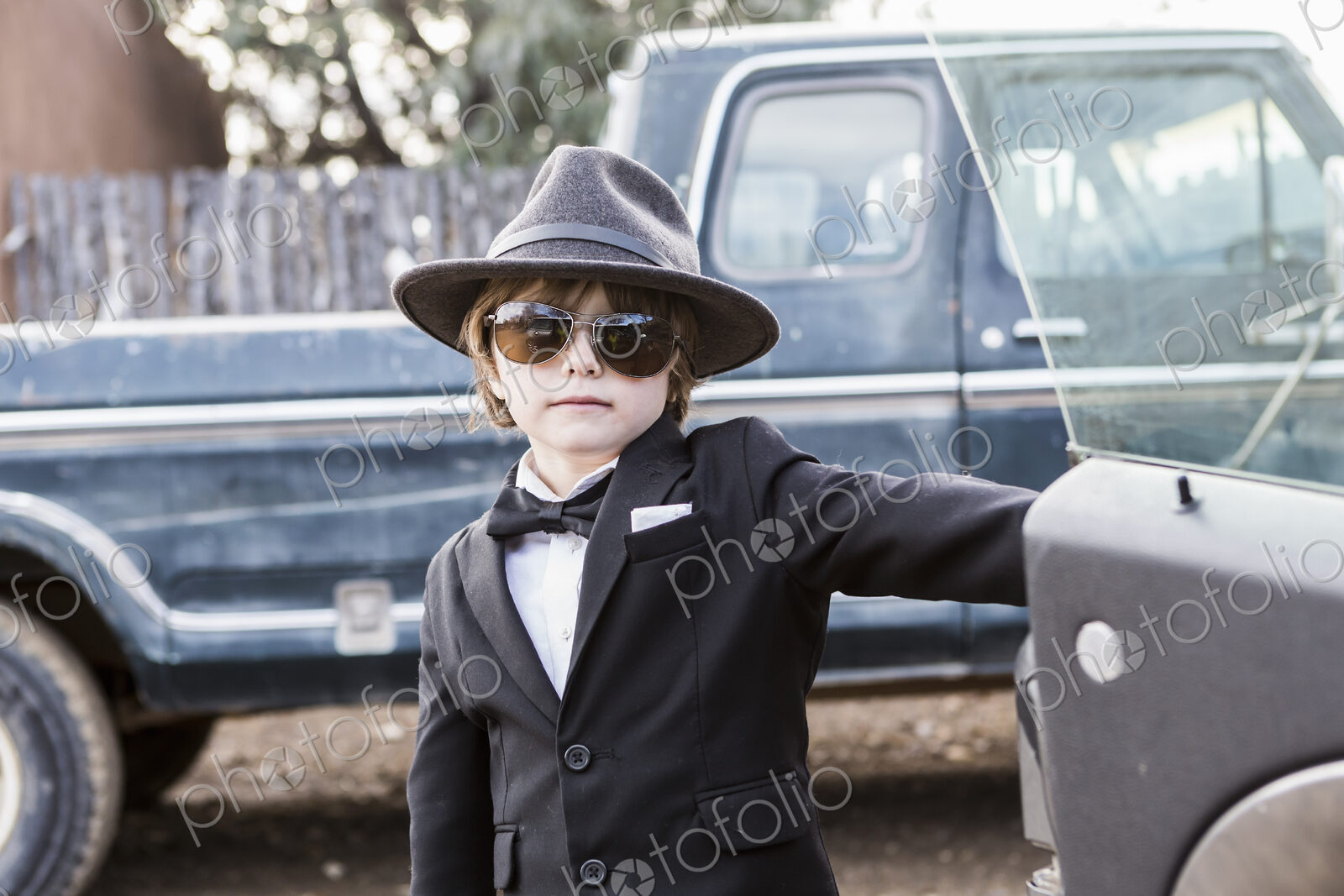 6 year old boy leaning on car open car door