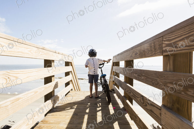 6 year old boy on wooden bridge with his bike