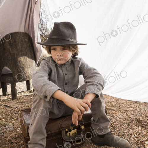 6 year old boy playing in an outdoor tent made of sheets 6 year old boy playing in an outdoor tent made of sheets
