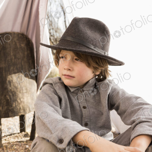 6 year old boy playing in an outdoor tent made of sheets 6 year old boy playing in an outdoor tent made of sheets