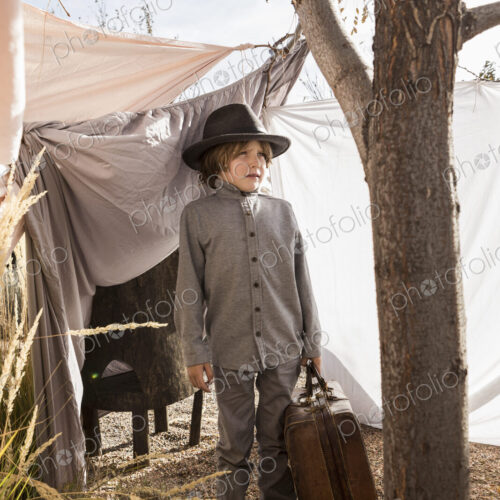 6 year old boy playing in an outdoor tent made of sheets 6 year old boy playing in an outdoor tent made of sheets