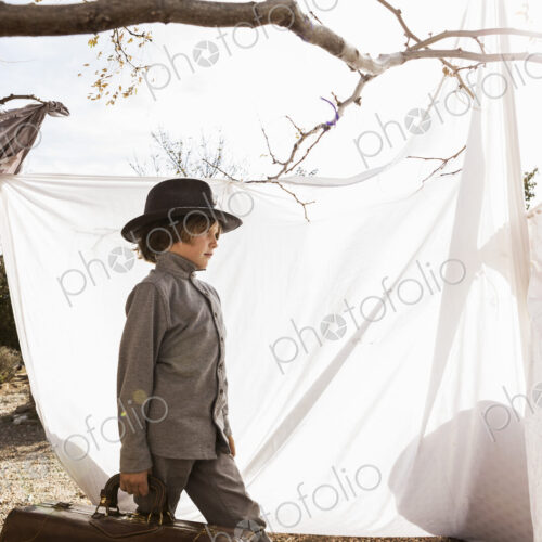 6 year old boy playing in an outdoor tent made of sheets 6 year old boy playing in an outdoor tent made of sheets