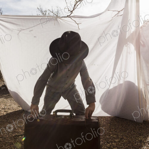 6 year old boy playing in an outdoor tent made of sheets 6 year old boy playing in an outdoor tent made of sheets
