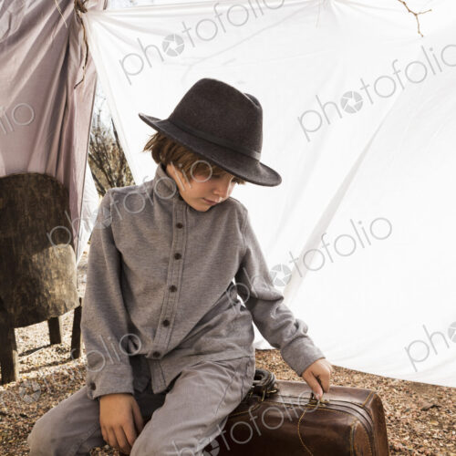 6 year old boy playing in an outdoor tent made of sheets 6 year old boy playing in an outdoor tent made of sheets