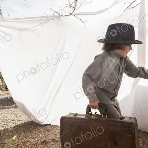 6 year old boy playing in an outdoor tent made of sheets 6 year old boy playing in an outdoor tent made of sheets