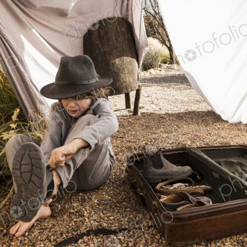 6 year old boy playing in an outdoor tent made of sheets 6 year old boy playing in an outdoor tent made of sheets