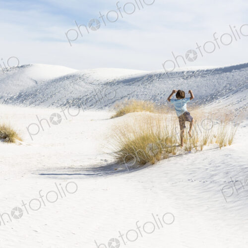 6 year old boy playing in sand dunes, White Sands Nat'l Monument, NM 6 year old boy playing in sand dunes, White Sands Nat'l Monument, NM