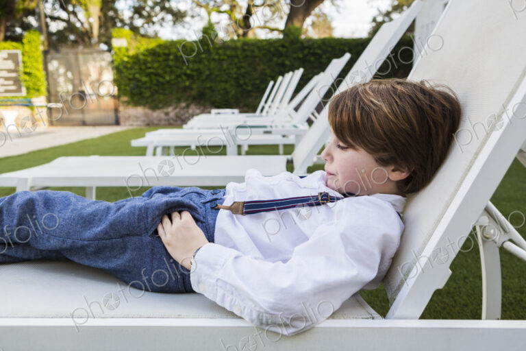 6 year old boy reclining on lawn chair