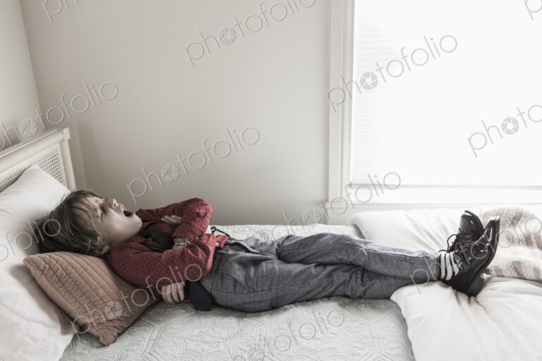6 year old boy resting on his bed