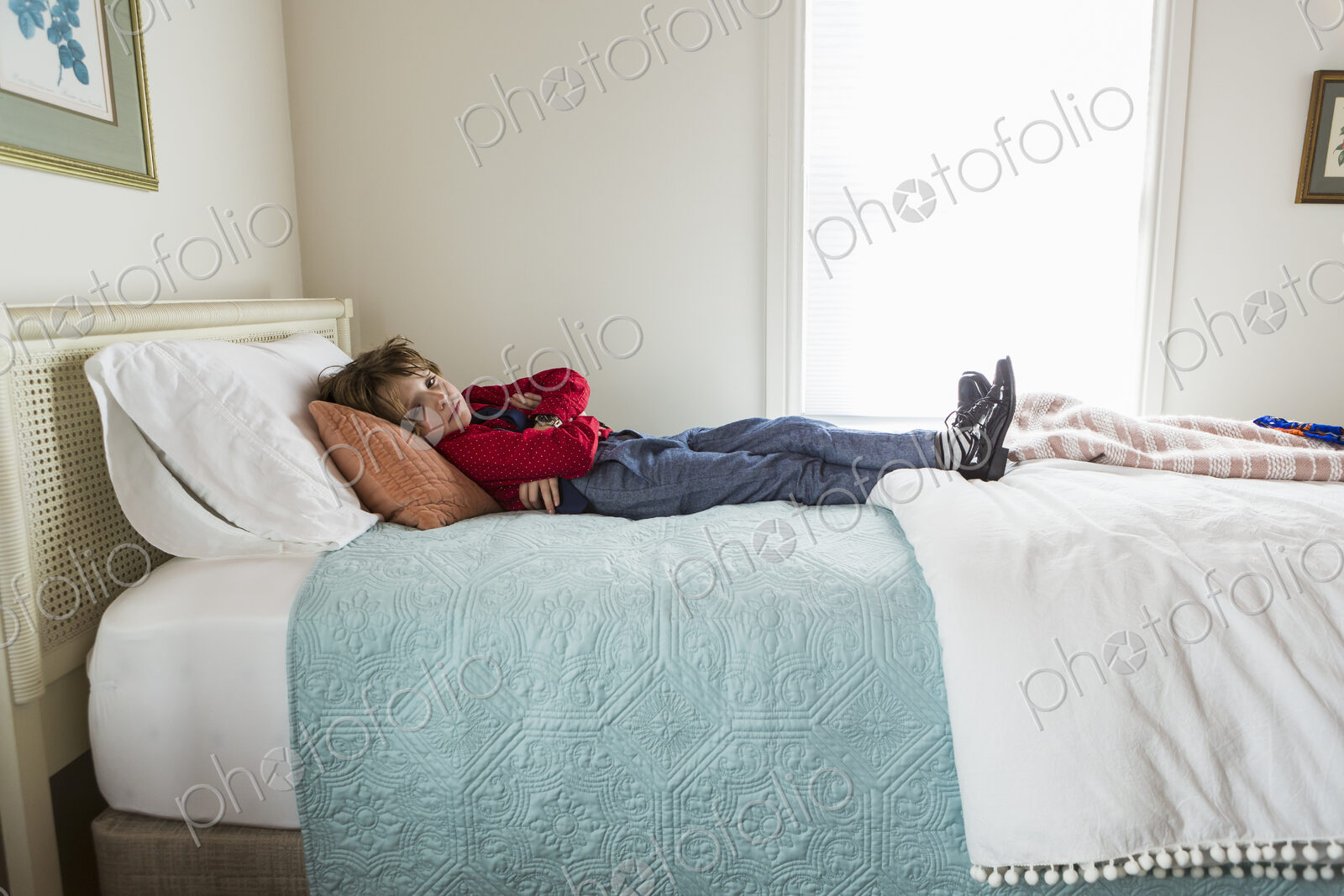 6 year old boy resting on his bed