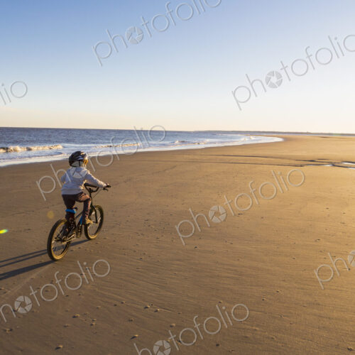 6 year old boy riding a bicycle on a beach 6 year old boy riding a bicycle on a beach