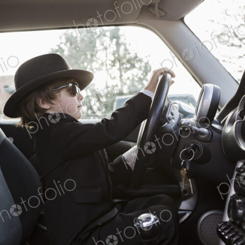 6 year old boy sitting in car holding steering wheel 6 year old boy sitting in car holding steering wheel