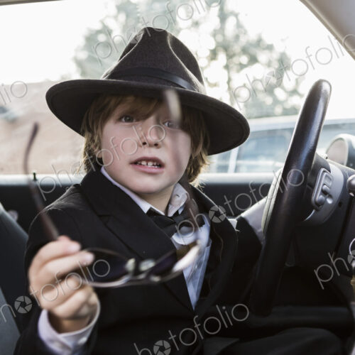 6 year old boy sitting in car holding steering wheel 6 year old boy sitting in car holding steering wheel