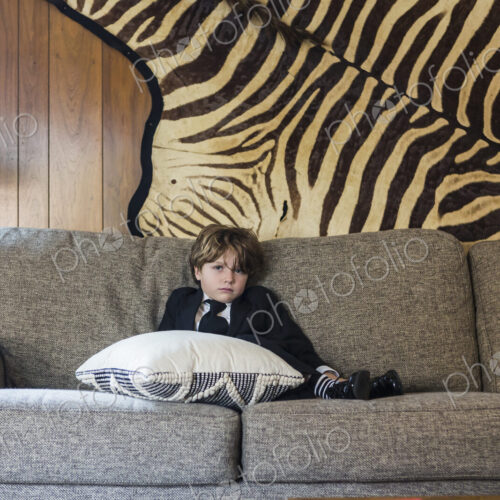 6 year old boy sitting on sofa