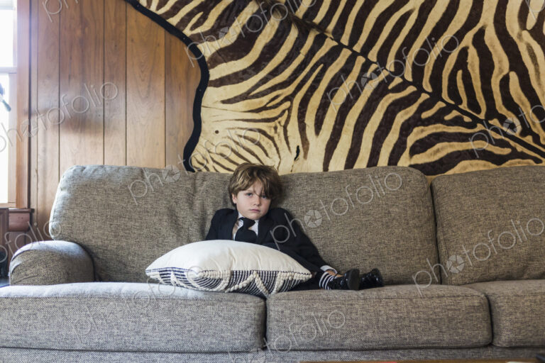 6 year old boy sitting on sofa