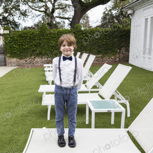 6 year old boy standing on lawn chair