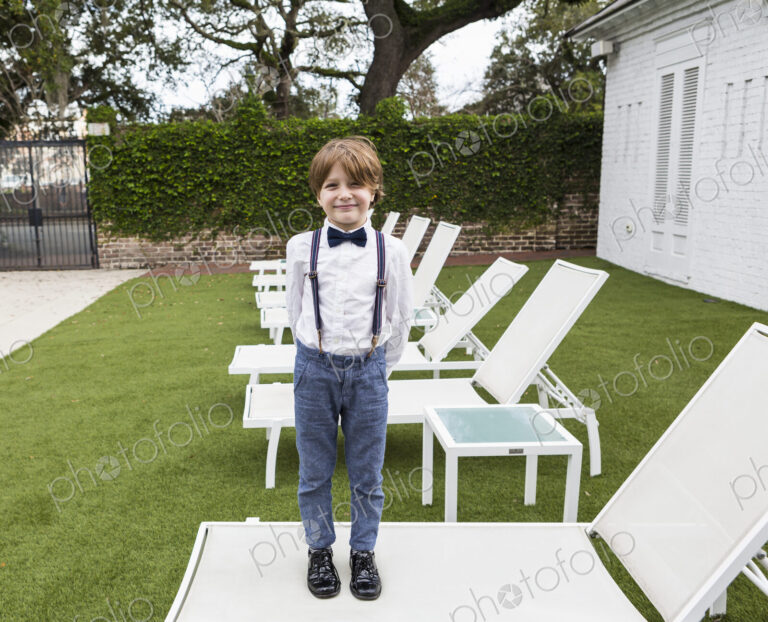 6 year old boy standing on lawn chair
